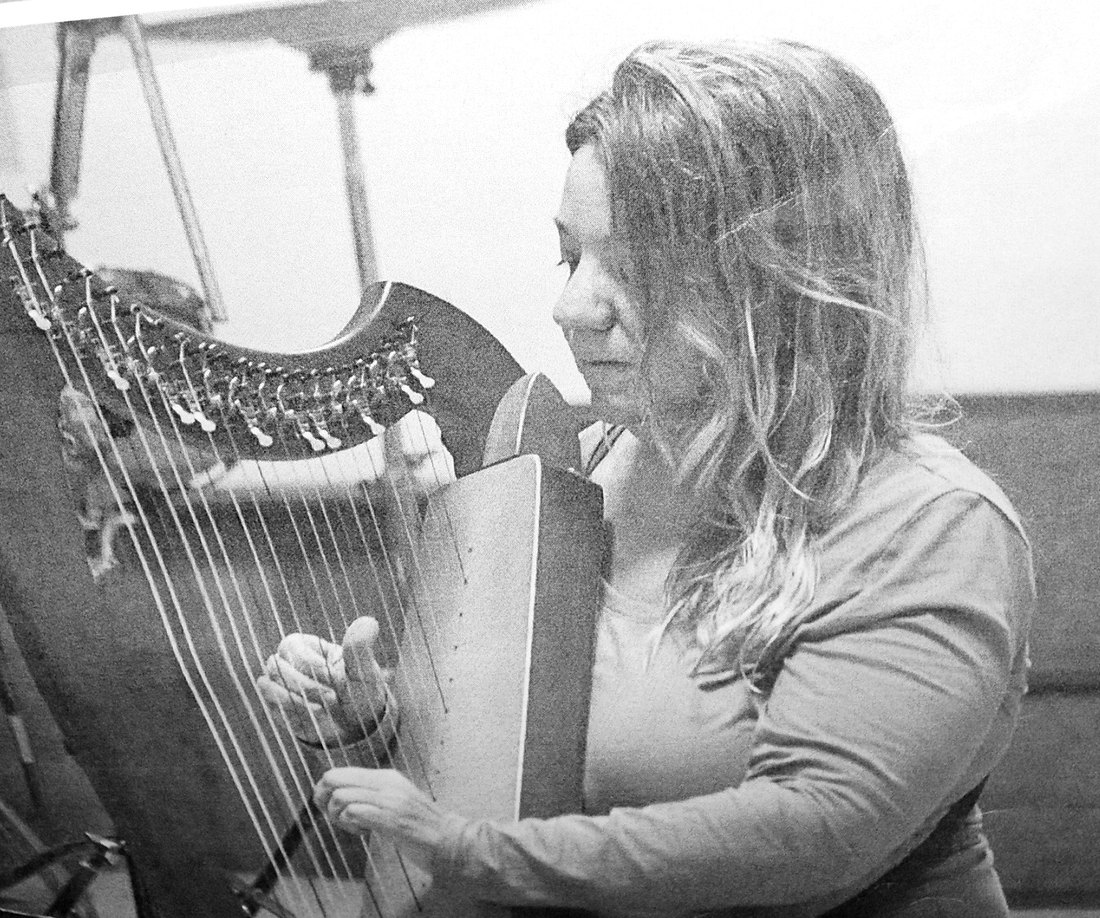 Patricia Turse playing a small lap harp